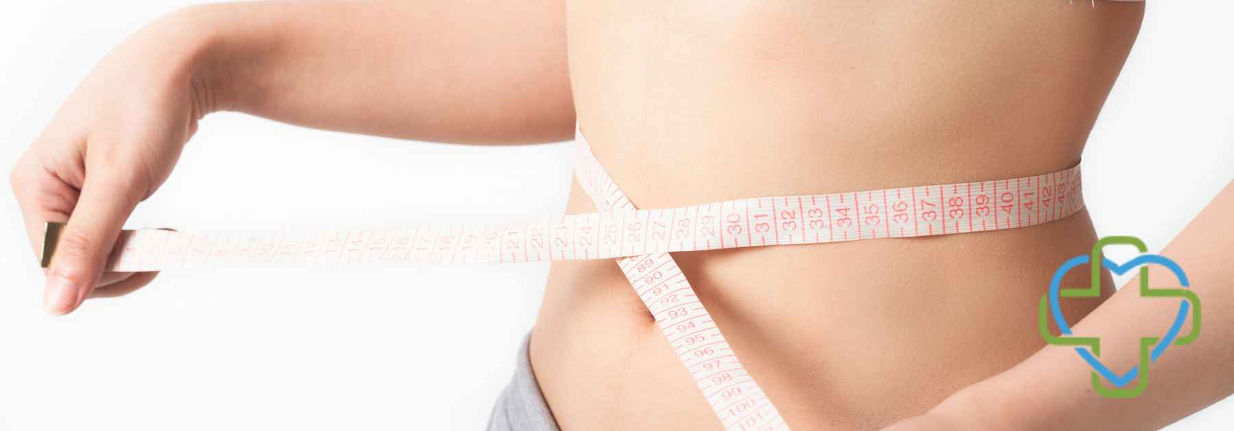 woman in crop top measuring waist