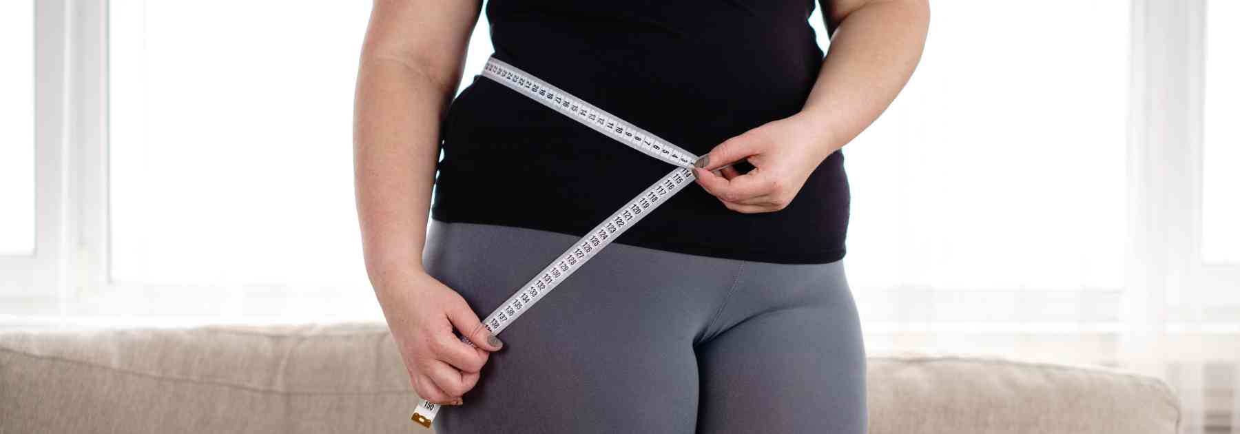overweight woman with measuring tape