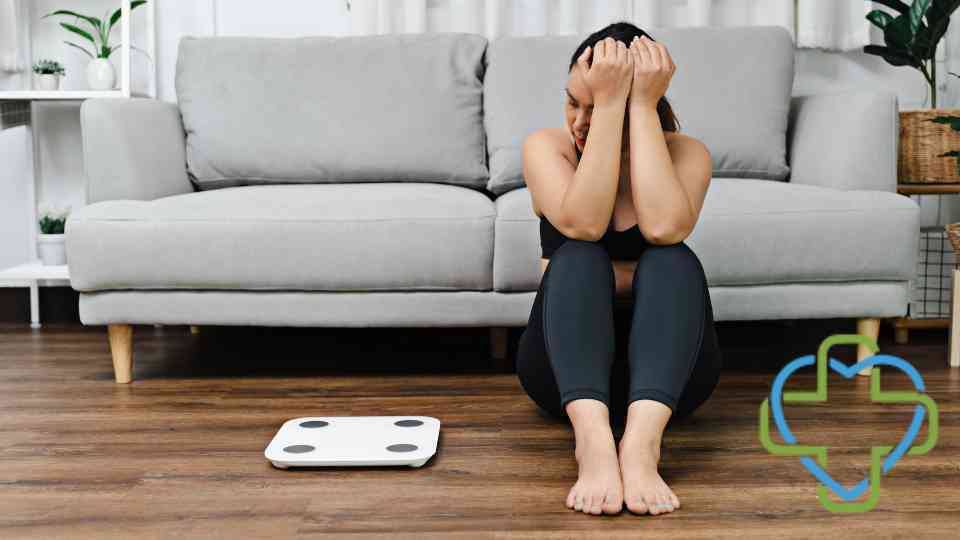 woman feeling frustrated looking at scales