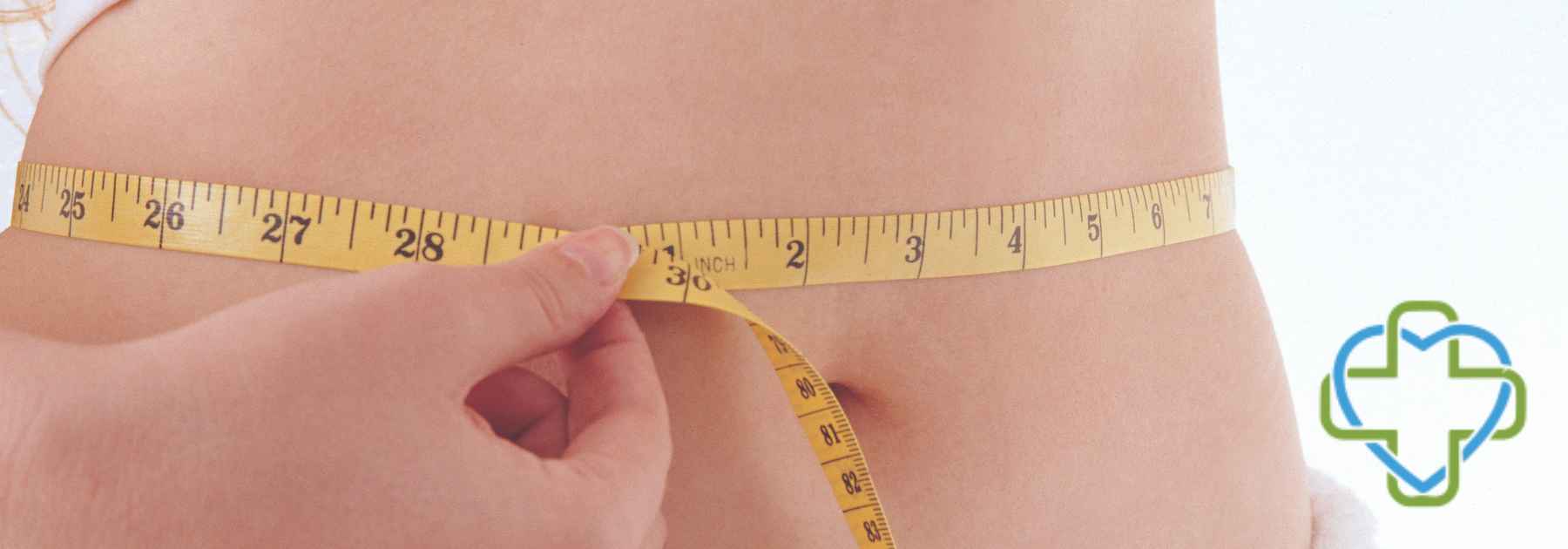 woman wearing towel measuring waist