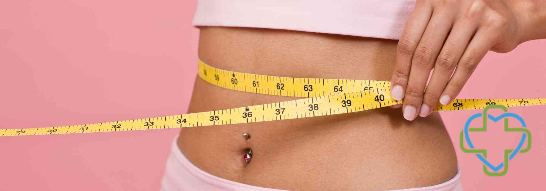 woman in pink clothes measuring waist