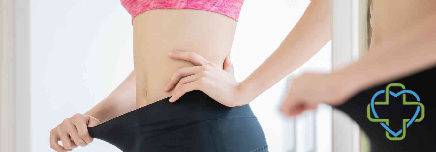 woman looking in mirror wearing leggings too big
