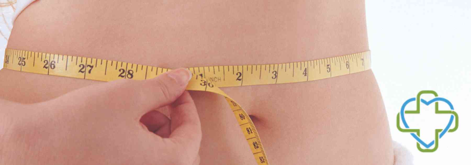 person measuring their waist