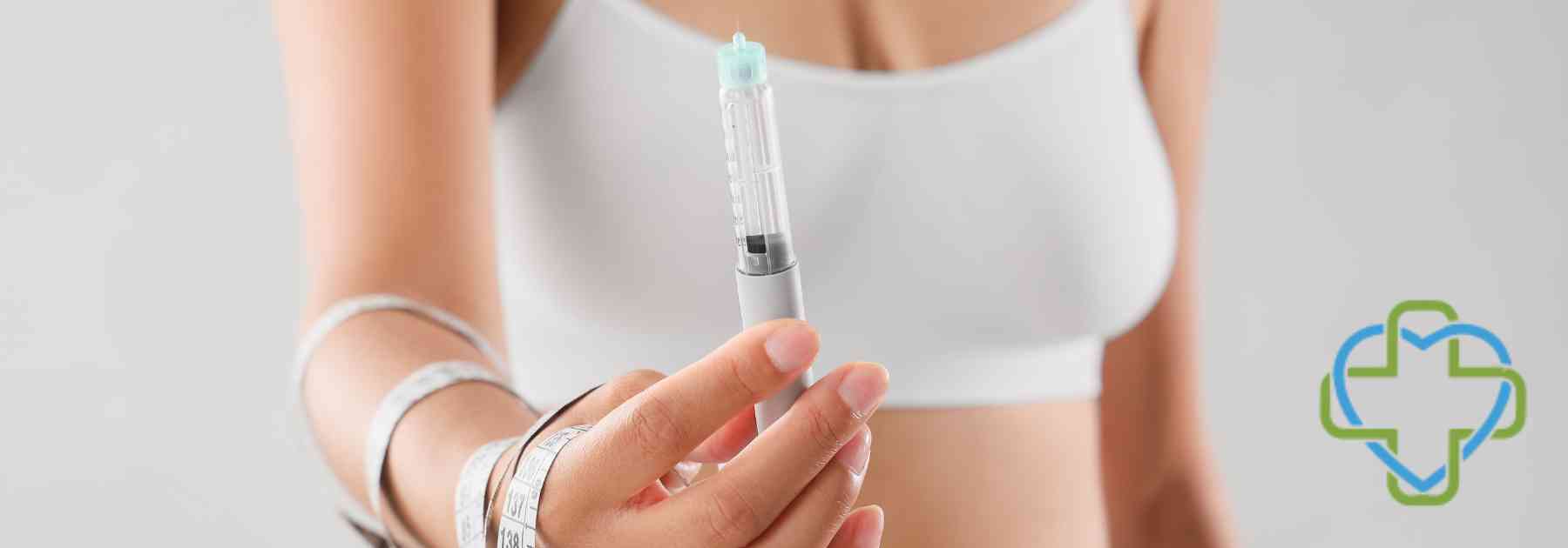 woman wearing white holding weight loss injection