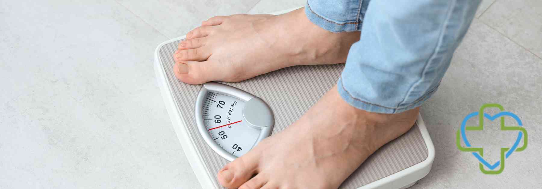 person wearing jeans standing on scales