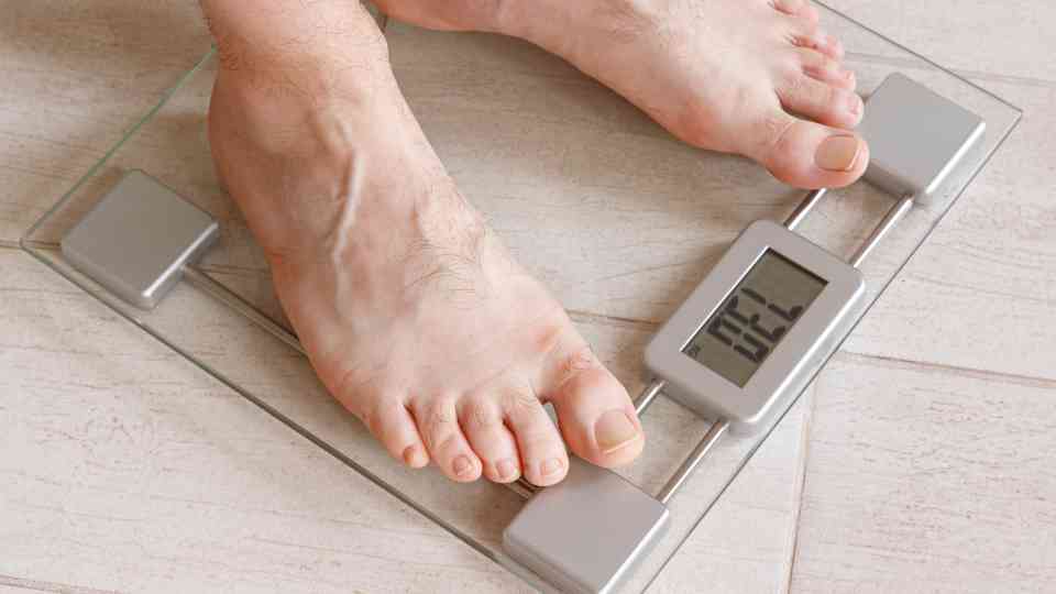 person in bare feet standing on scales