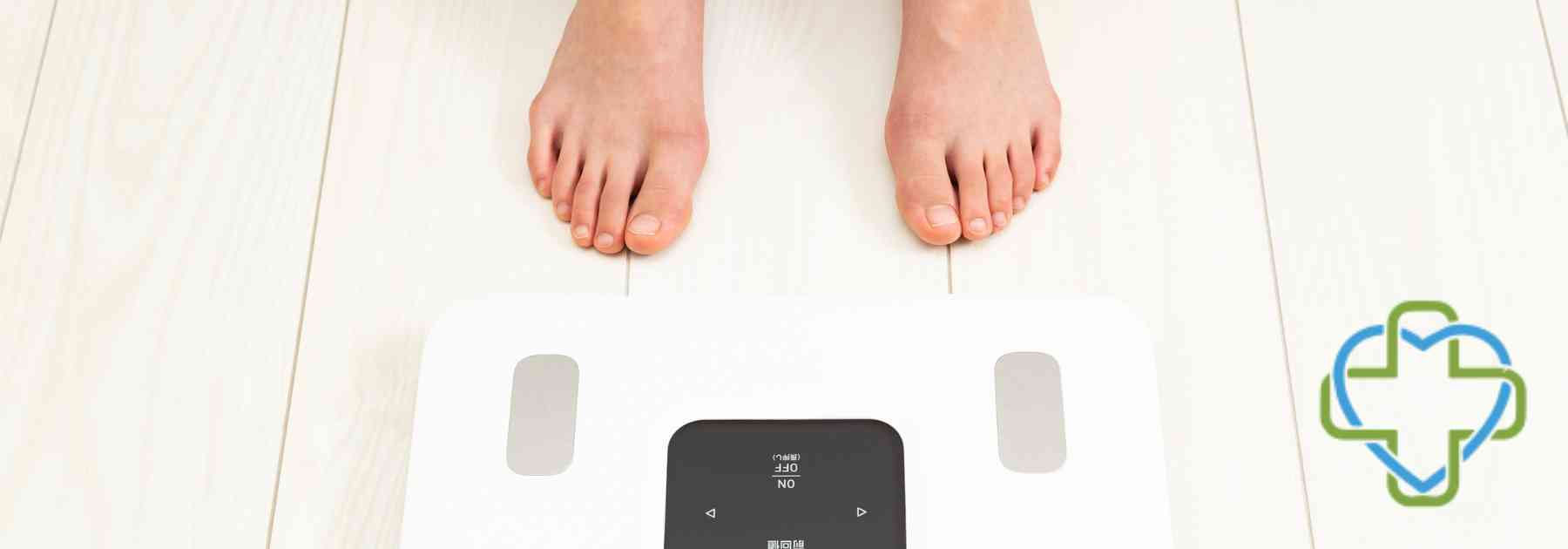 person in bare feet standing in front of scales