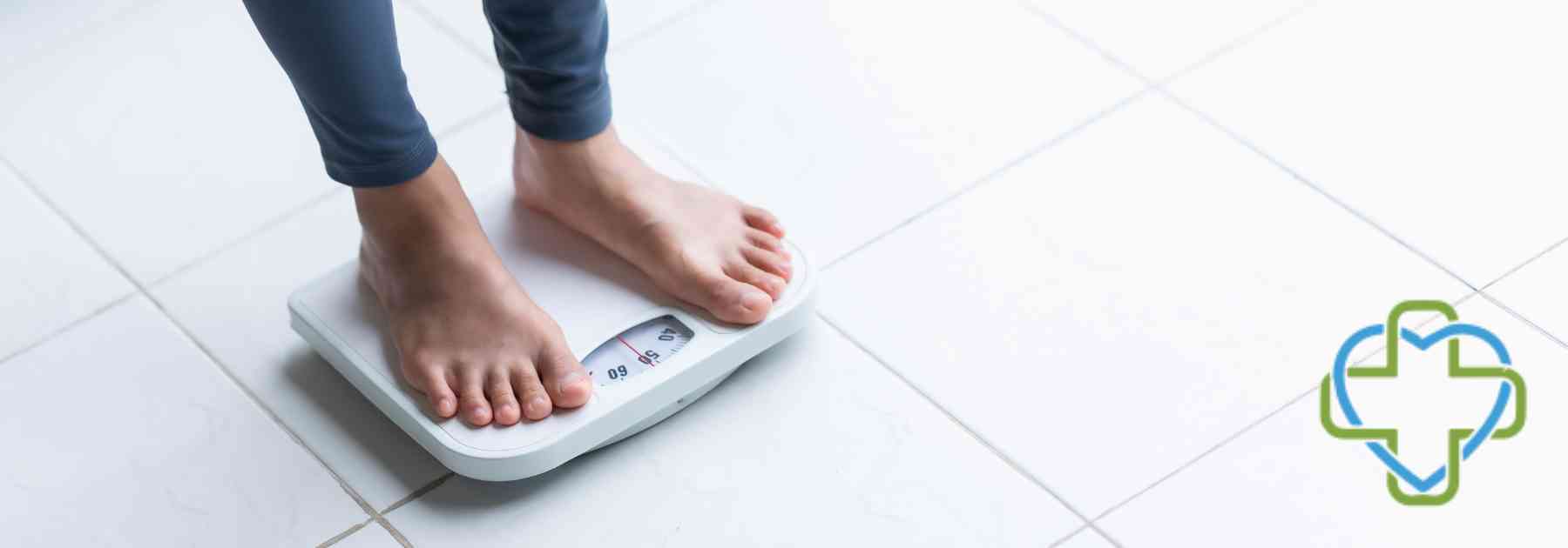 woman in workout gear standing on scales in bare feet