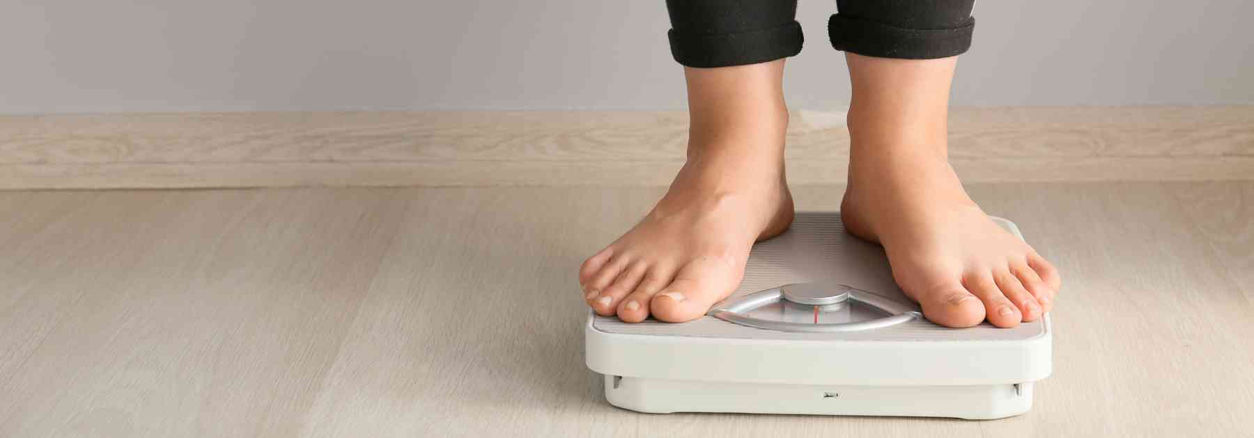 person in bare feet standing on scales