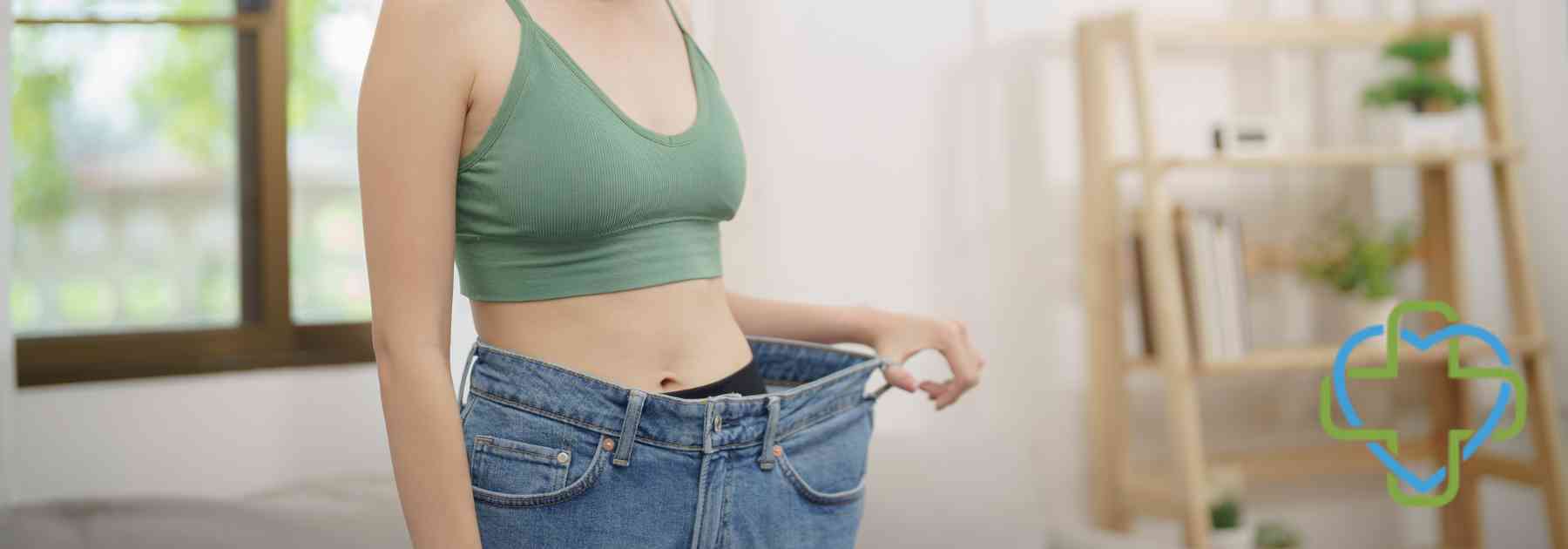 young woman in green crop top wearing jeans too big