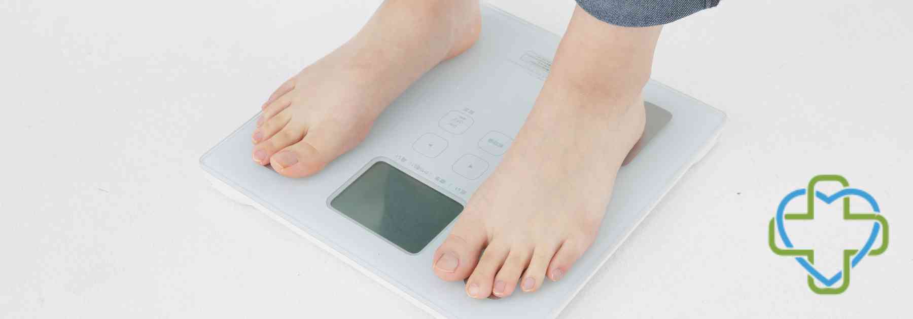 person in bare feet standing on scales