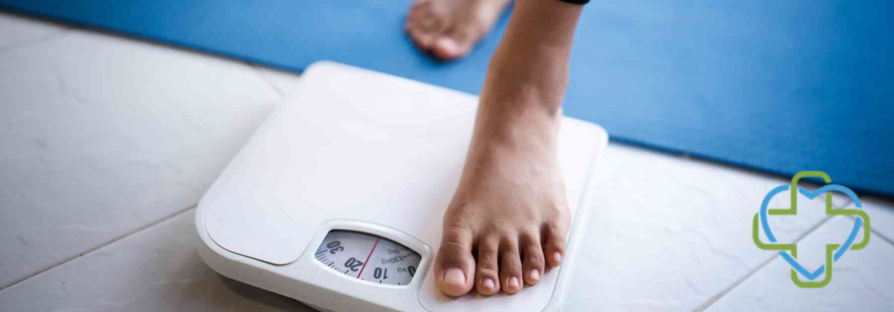 person in bare feet stepping on scales