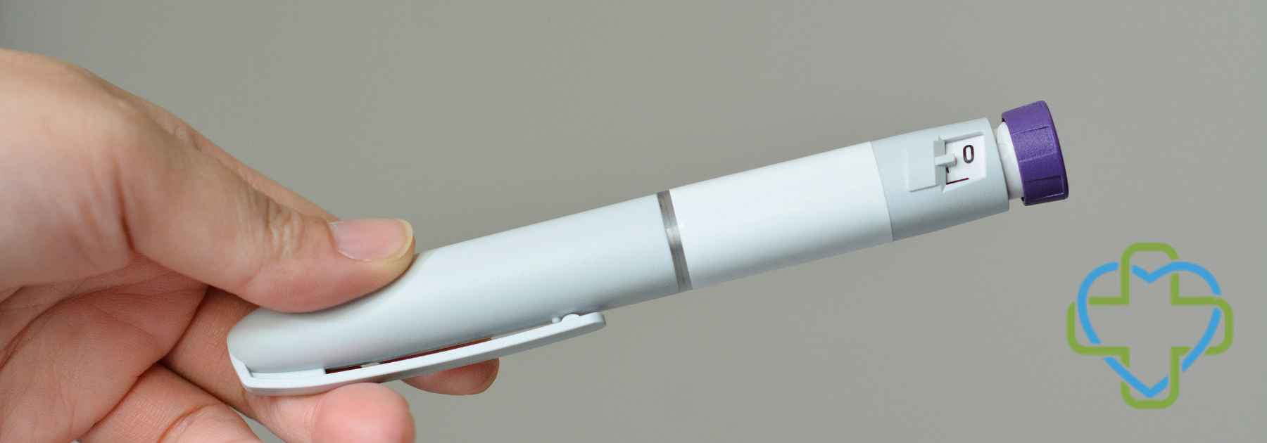 person holding weight loss injection on grey background