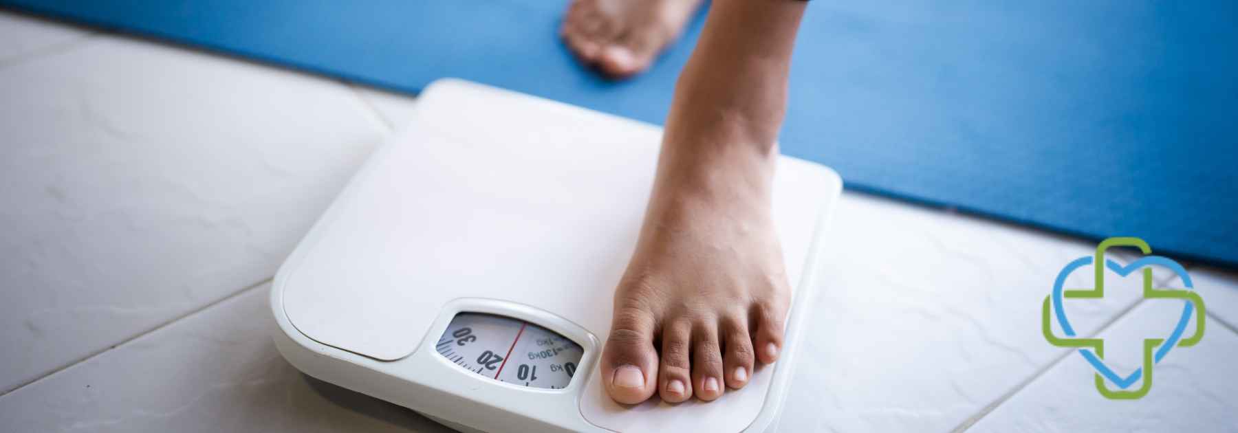 person in bare feet stepping on scales