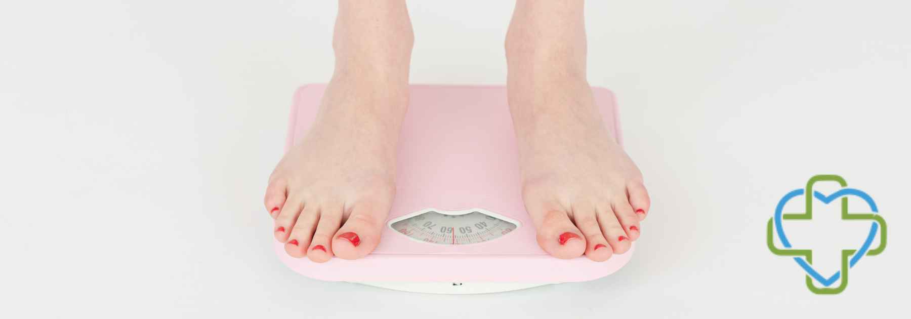 woman in bare feet standing on pink scales