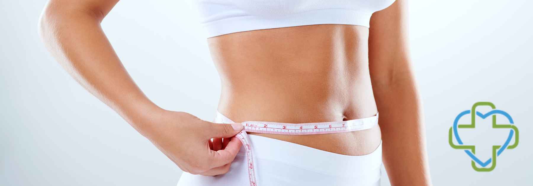 woman in white workout gear measuring waist