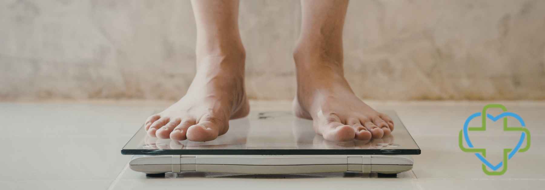 person in bare feet standing on scales in tiled room