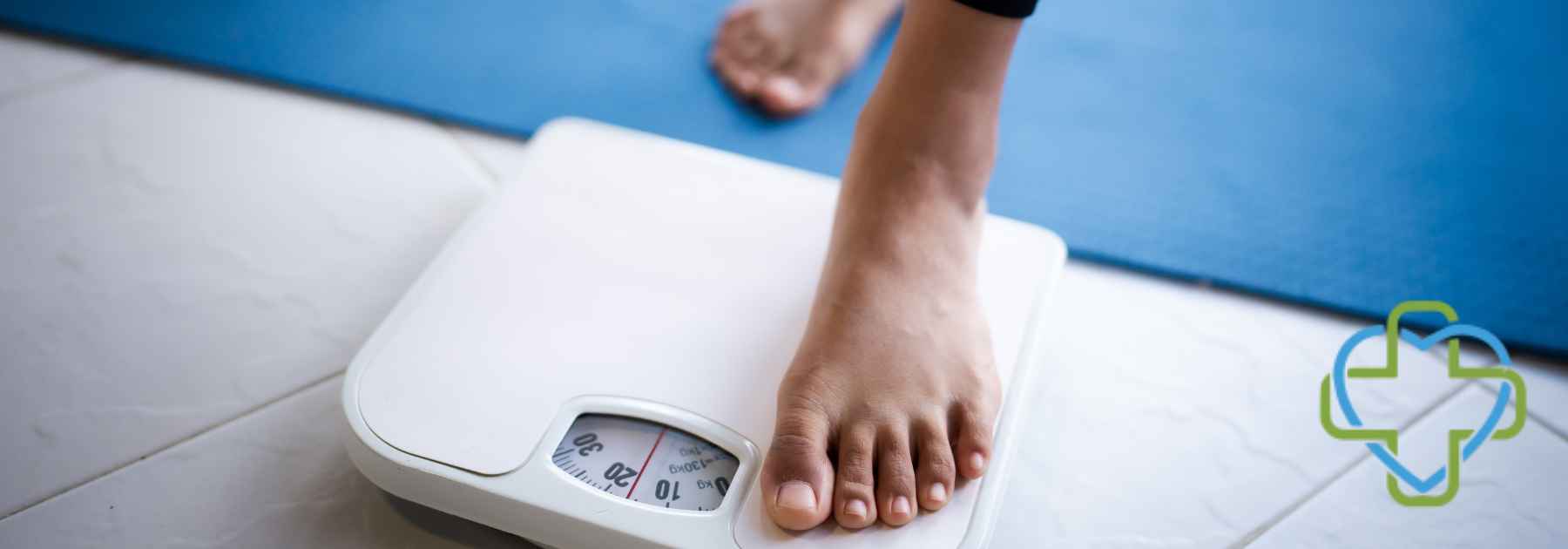 person in bare feet stepping on scales